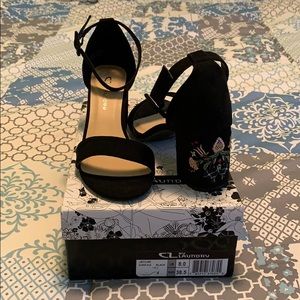 Black strappy block heels with sewn floral detail